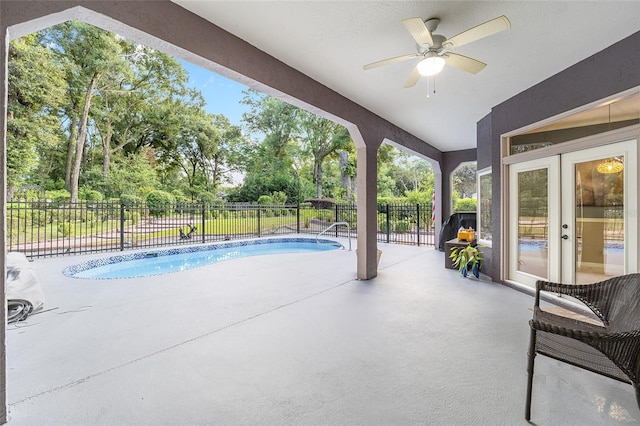 view of swimming pool with ceiling fan and a patio