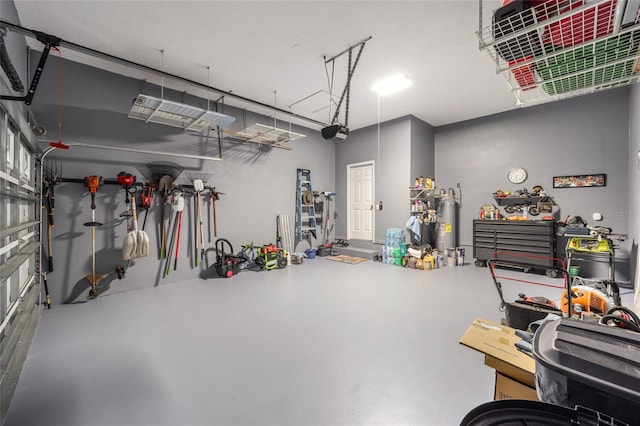 garage with electric water heater and a garage door opener