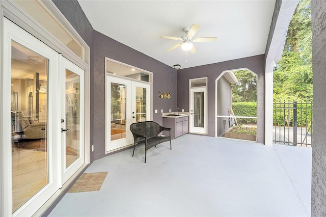 interior space featuring ceiling fan, sink, and french doors