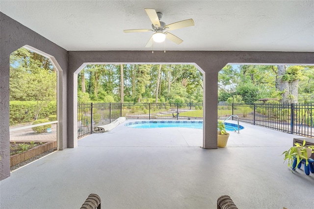 view of patio / terrace with a fenced in pool and ceiling fan