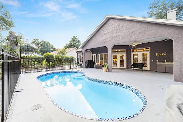 view of pool featuring area for grilling, ceiling fan, a patio, and french doors