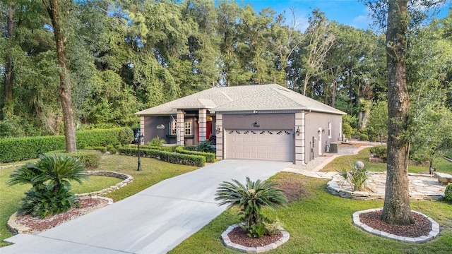 view of front of house with a garage and a front yard