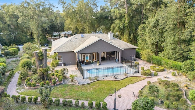 view of swimming pool featuring a lawn and a patio