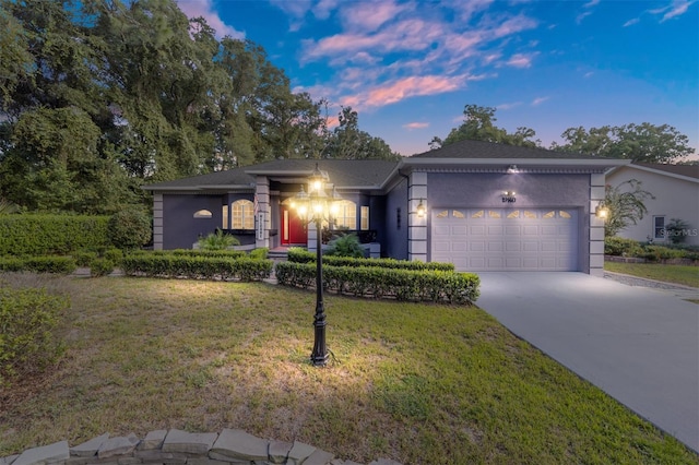 view of front facade with a garage and a lawn