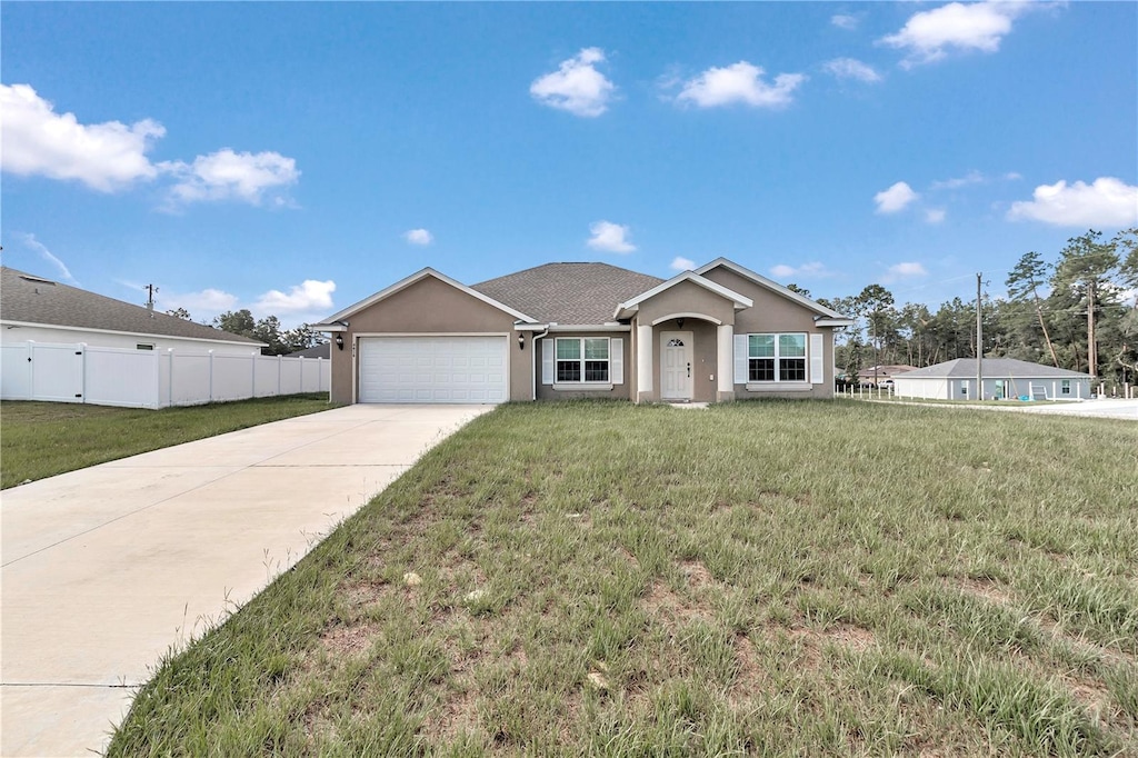 single story home featuring a front yard, fence, driveway, and stucco siding