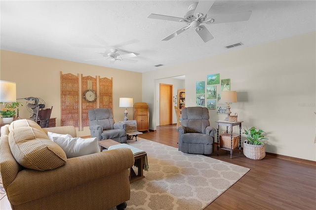 living room with ceiling fan and hardwood / wood-style flooring