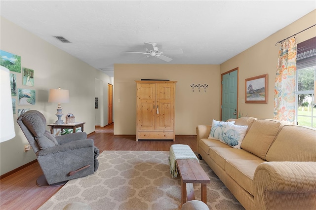 living room with ceiling fan and hardwood / wood-style flooring