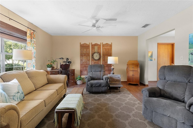 living room with ceiling fan and wood-type flooring