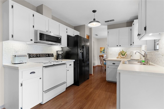 kitchen featuring white cabinetry, dark wood-type flooring, tasteful backsplash, white electric range, and decorative light fixtures