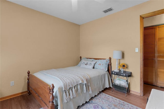 bedroom featuring a closet, ceiling fan, and hardwood / wood-style flooring