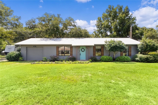 ranch-style house featuring a front yard and a garage