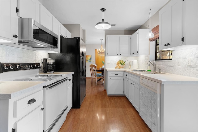 kitchen with white cabinets, pendant lighting, sink, white appliances, and light hardwood / wood-style flooring