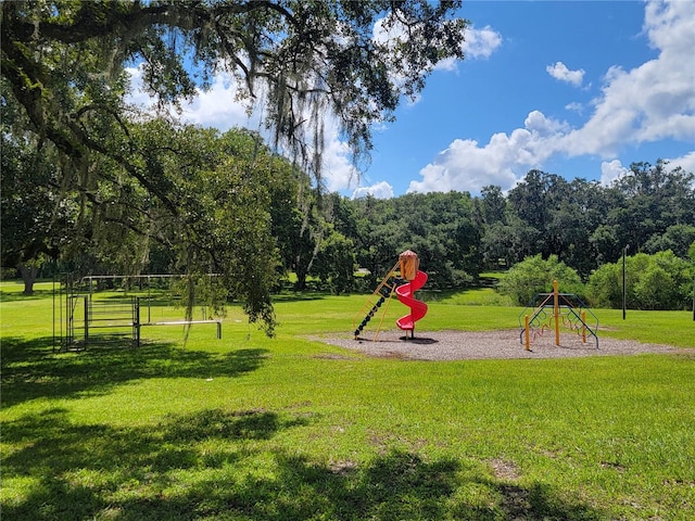 view of home's community with a lawn and a playground