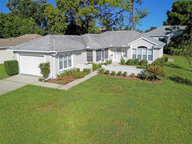 single story home featuring a front yard and a garage