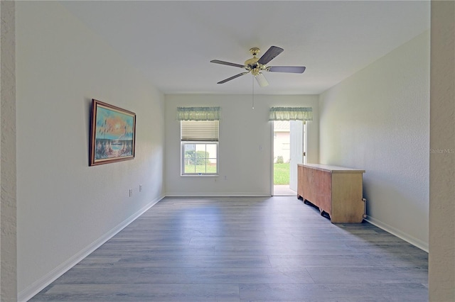 empty room with light hardwood / wood-style floors and ceiling fan