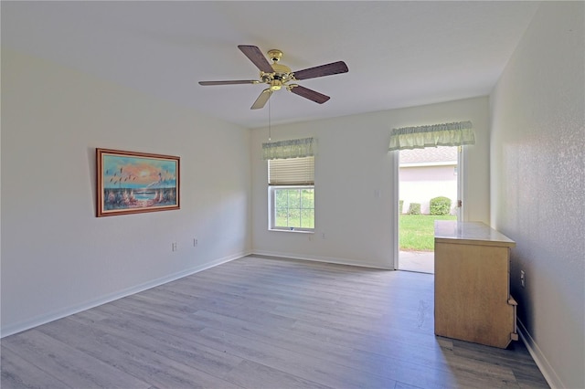 spare room featuring light hardwood / wood-style flooring and ceiling fan