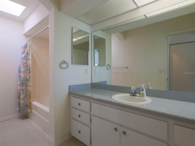 bathroom featuring vanity, shower / tub combo with curtain, and a skylight