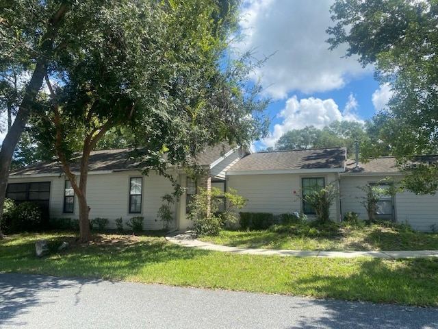 single story home featuring a front lawn