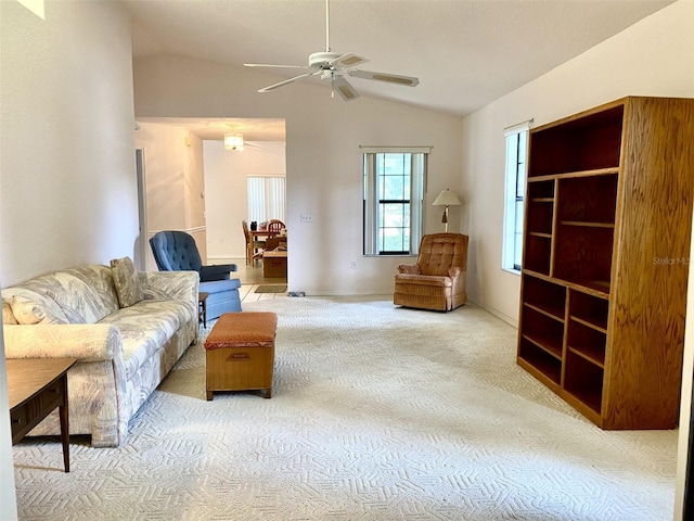 living room with ceiling fan, lofted ceiling, and carpet