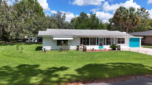 ranch-style house with a garage and a front yard