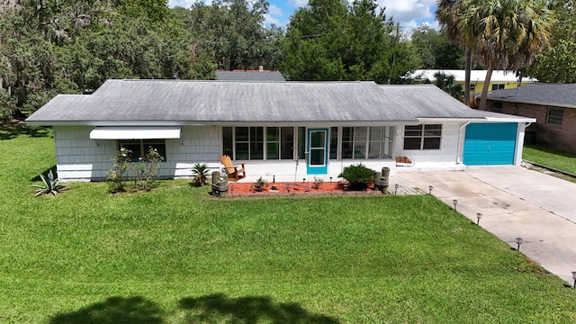 ranch-style home with a garage and a front yard