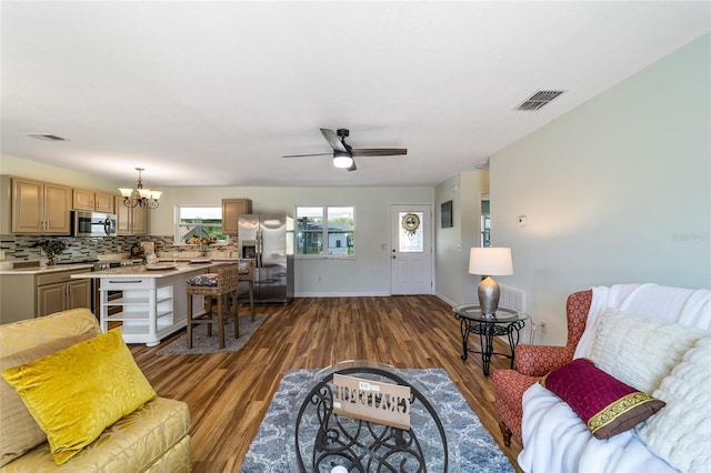 living room with wood finished floors, a chandelier, ceiling fan, and baseboards