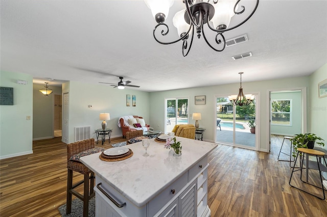 kitchen with a chandelier, open floor plan, dark wood-style flooring, and decorative light fixtures