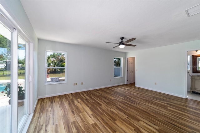 unfurnished room featuring wood finished floors, baseboards, and a ceiling fan