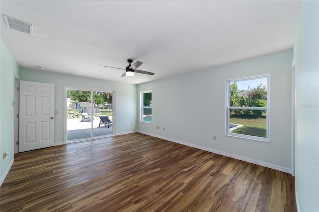 spare room featuring dark wood-style flooring, baseboards, and ceiling fan