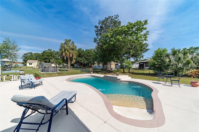 view of swimming pool featuring a lawn and a patio area