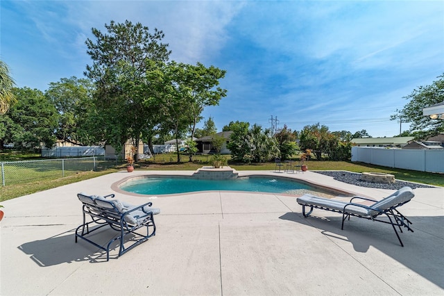 view of pool with a lawn and a patio