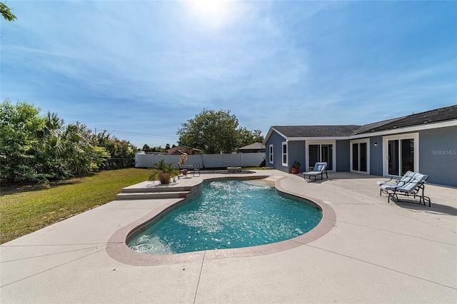 view of swimming pool with a lawn and a patio area