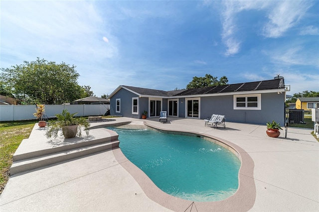 view of swimming pool with a patio, a fenced backyard, and a hot tub