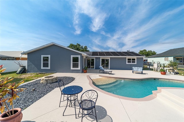 view of swimming pool featuring a fire pit, a patio area, and fence
