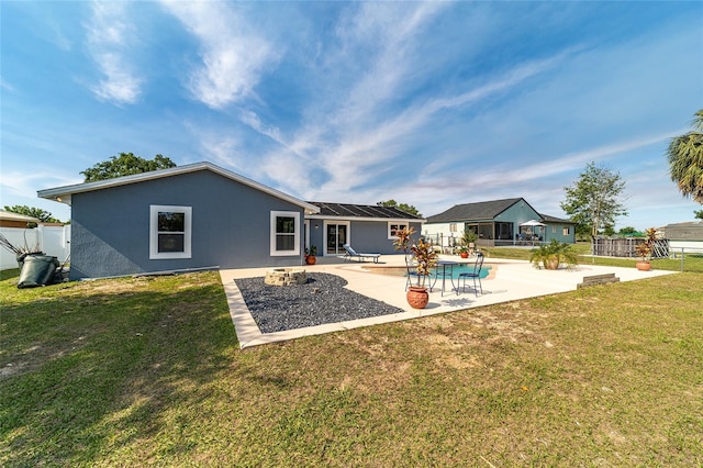 rear view of house with a lawn and a patio area