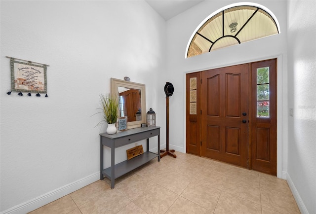 tiled entryway featuring a high ceiling