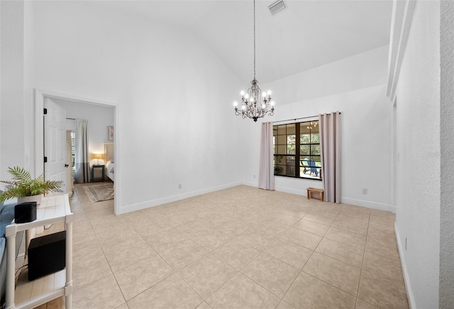 tiled spare room featuring high vaulted ceiling and an inviting chandelier