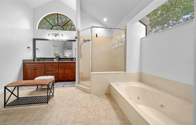 bathroom featuring plus walk in shower, vanity, tile patterned floors, and lofted ceiling