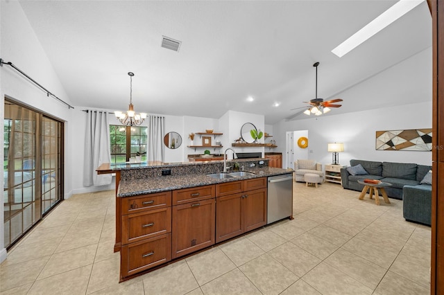 kitchen featuring dishwasher, lofted ceiling with skylight, ceiling fan with notable chandelier, sink, and decorative light fixtures