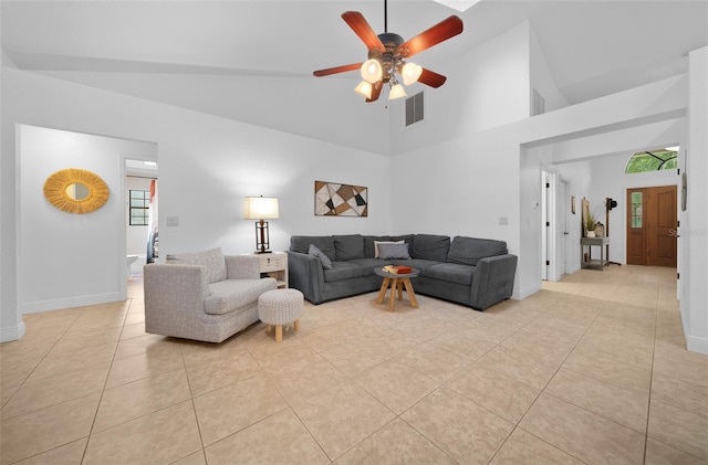 living room with ceiling fan, light tile patterned floors, and high vaulted ceiling