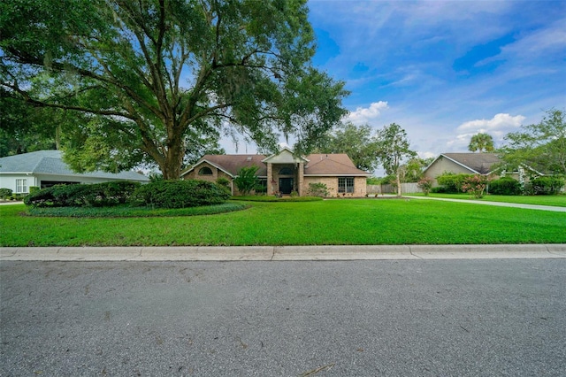 ranch-style home featuring a front lawn