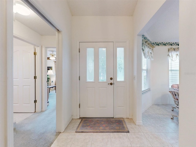 tiled foyer entrance with a wealth of natural light