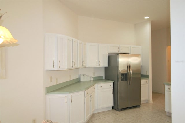 kitchen with white cabinetry, stainless steel fridge with ice dispenser, and light tile patterned floors