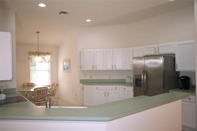 kitchen featuring pendant lighting, kitchen peninsula, stainless steel fridge with ice dispenser, a notable chandelier, and white cabinetry