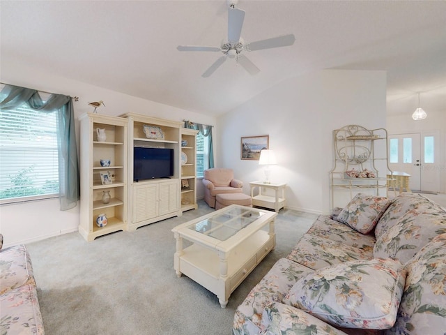 carpeted living room with ceiling fan and lofted ceiling