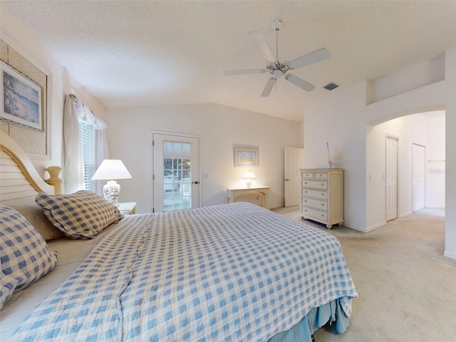 carpeted bedroom featuring ceiling fan, a textured ceiling, and vaulted ceiling