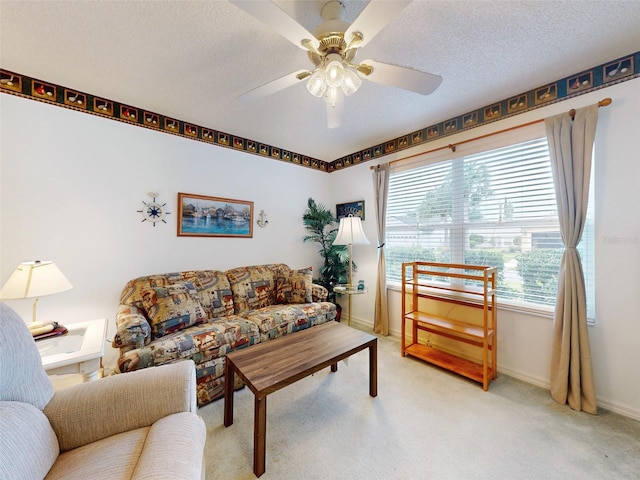 carpeted living room with a textured ceiling and ceiling fan