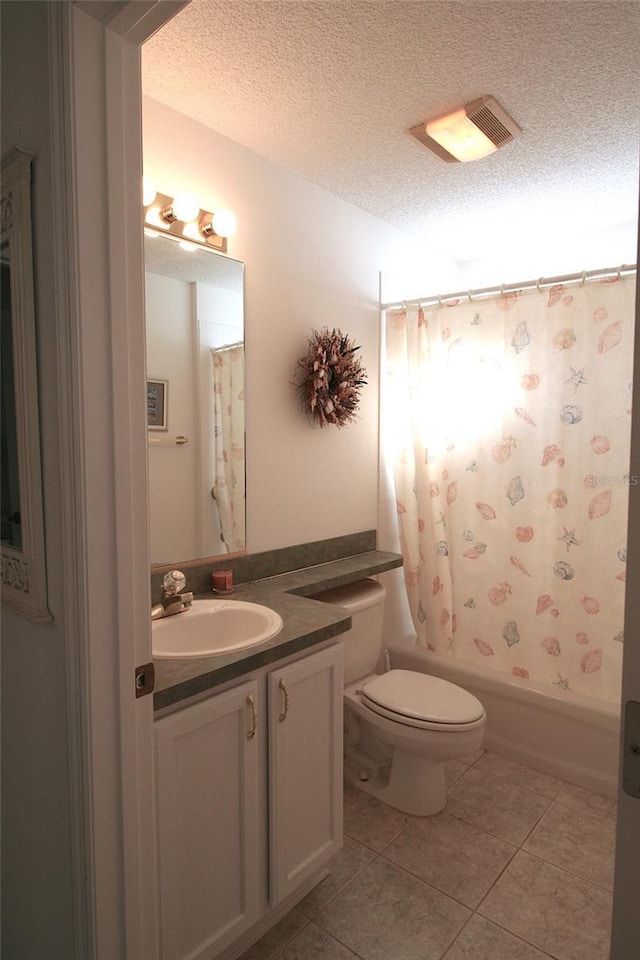 full bathroom featuring shower / bath combination with curtain, tile patterned floors, vanity, a textured ceiling, and toilet