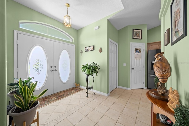 tiled foyer entrance featuring a textured ceiling and french doors