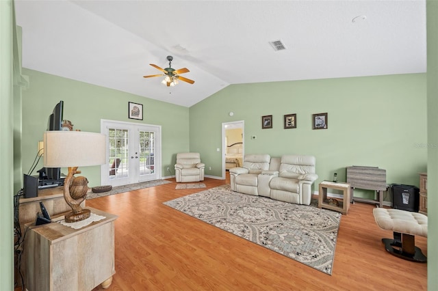 living room featuring light wood-type flooring, french doors, lofted ceiling, and ceiling fan